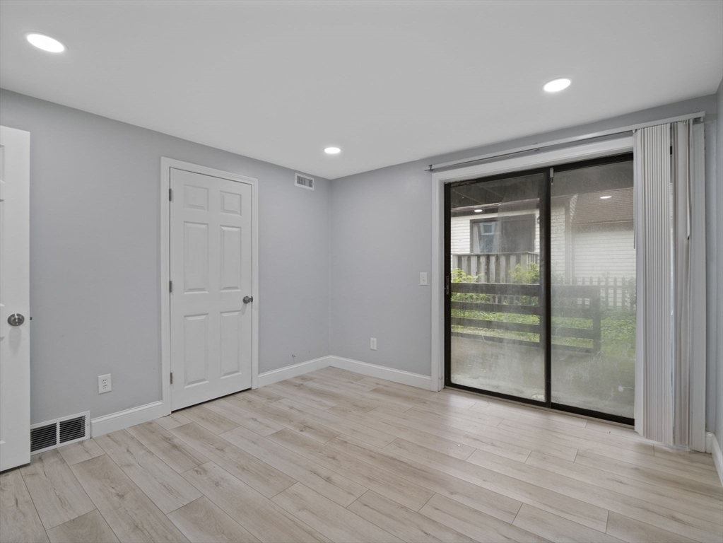 24 Bettys Pond Road, Unit K Barnstable, MA 02601 - Photo 27 of 40 an empty room with wooden floor