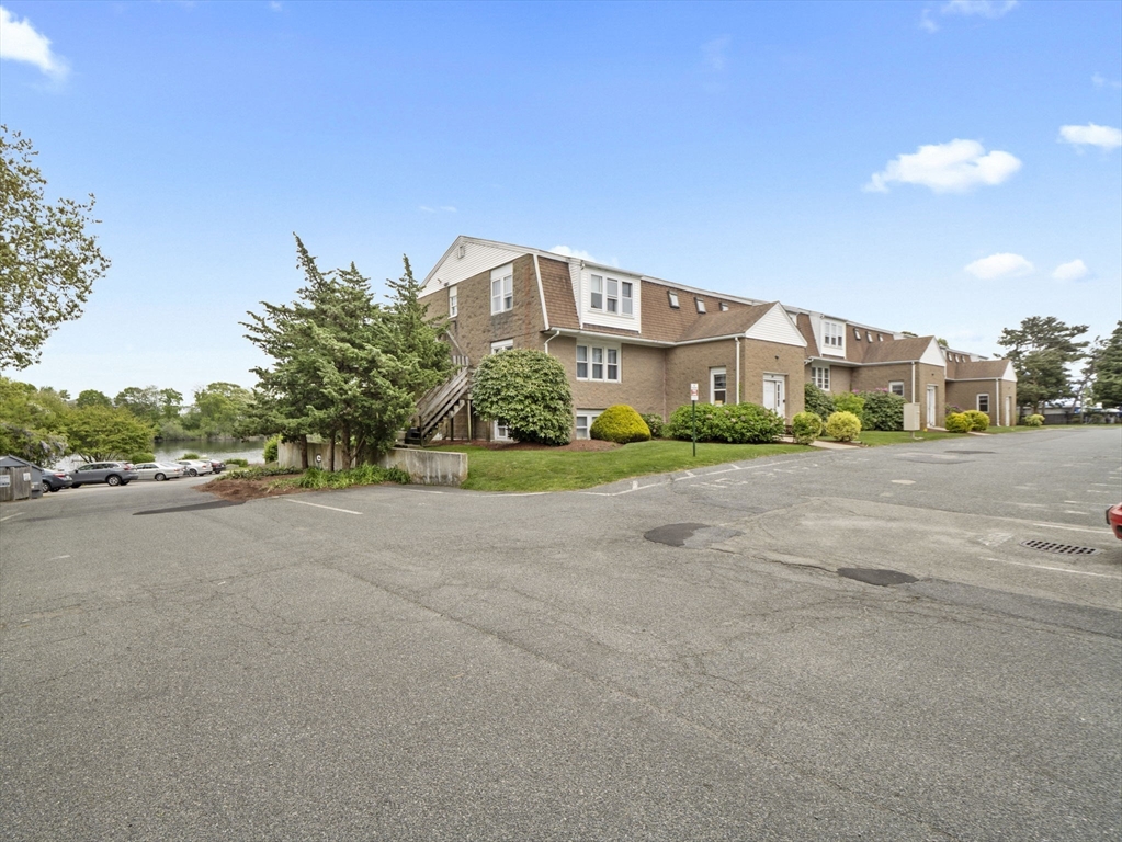 24 Bettys Pond Road, Unit K Barnstable, MA 02601 - Photo 3 of 40 a view of a street with a building in the background