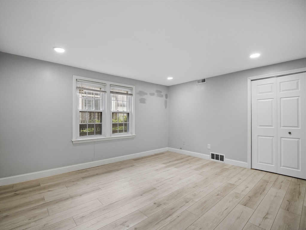 24 Bettys Pond Road, Unit K Barnstable, MA 02601 - Photo 38 of 40 a view of empty room with wooden floor and fan