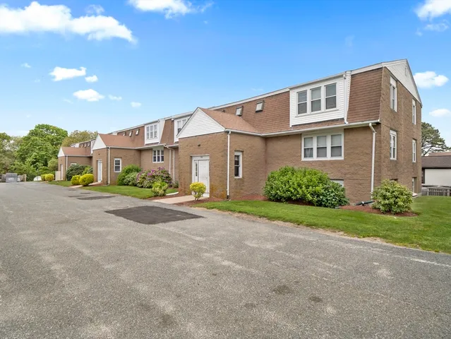 a view of a blue house with a street