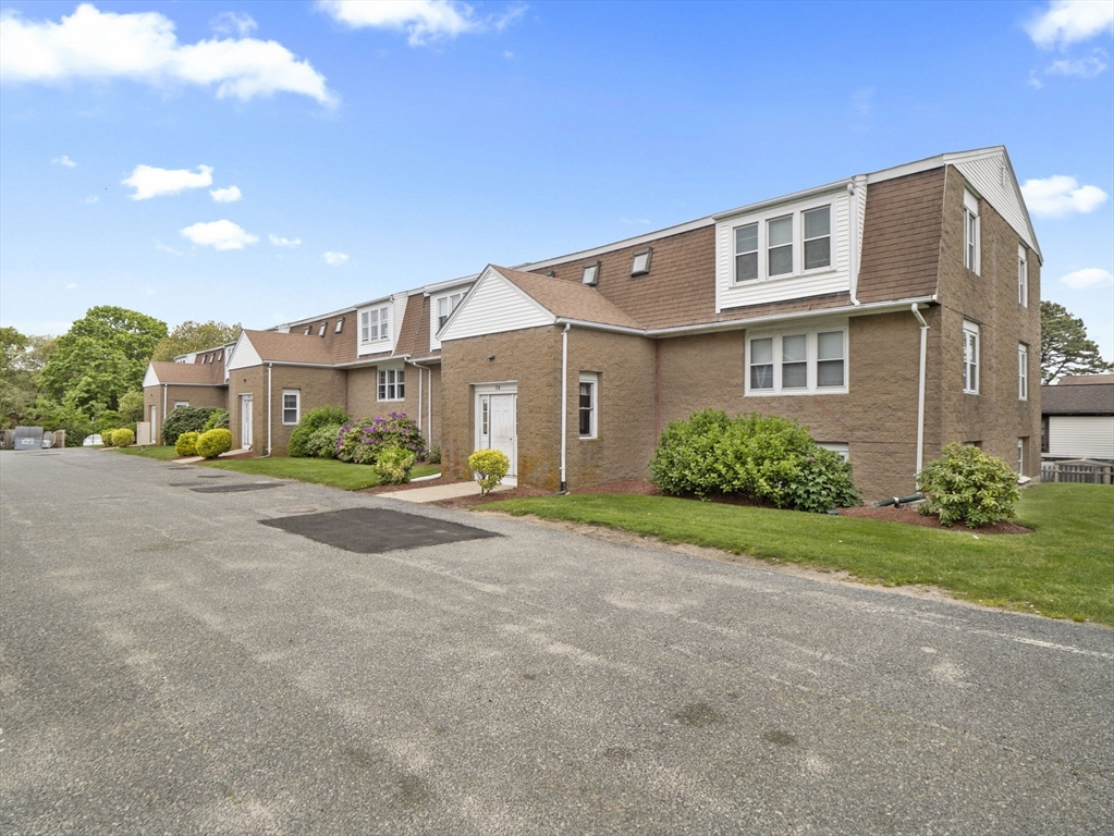 24 Bettys Pond Road, Unit K Barnstable, MA 02601 - Photo 5 of 40 a view of a blue house with a street