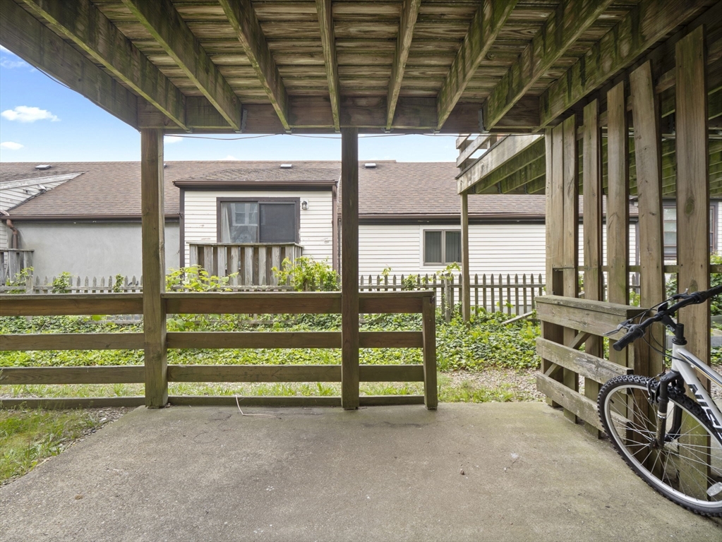 24 Bettys Pond Road, Unit K Barnstable, MA 02601 - Photo 8 of 40 a view of a porch with a small yard