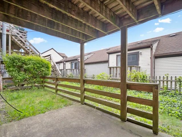 a view of backyard with large trees and a small yard
