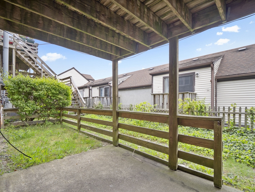 24 Bettys Pond Road, Unit K Barnstable, MA 02601 - Photo 9 of 40 a view of backyard with large trees and a small yard