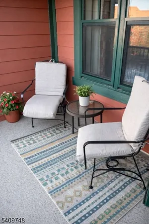 a living room with furniture and a rug