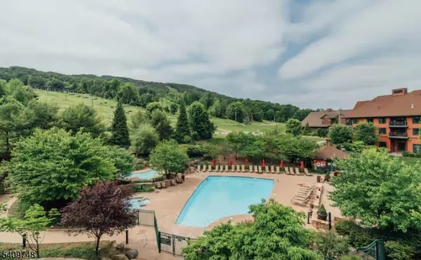 a small pool with trees in the background