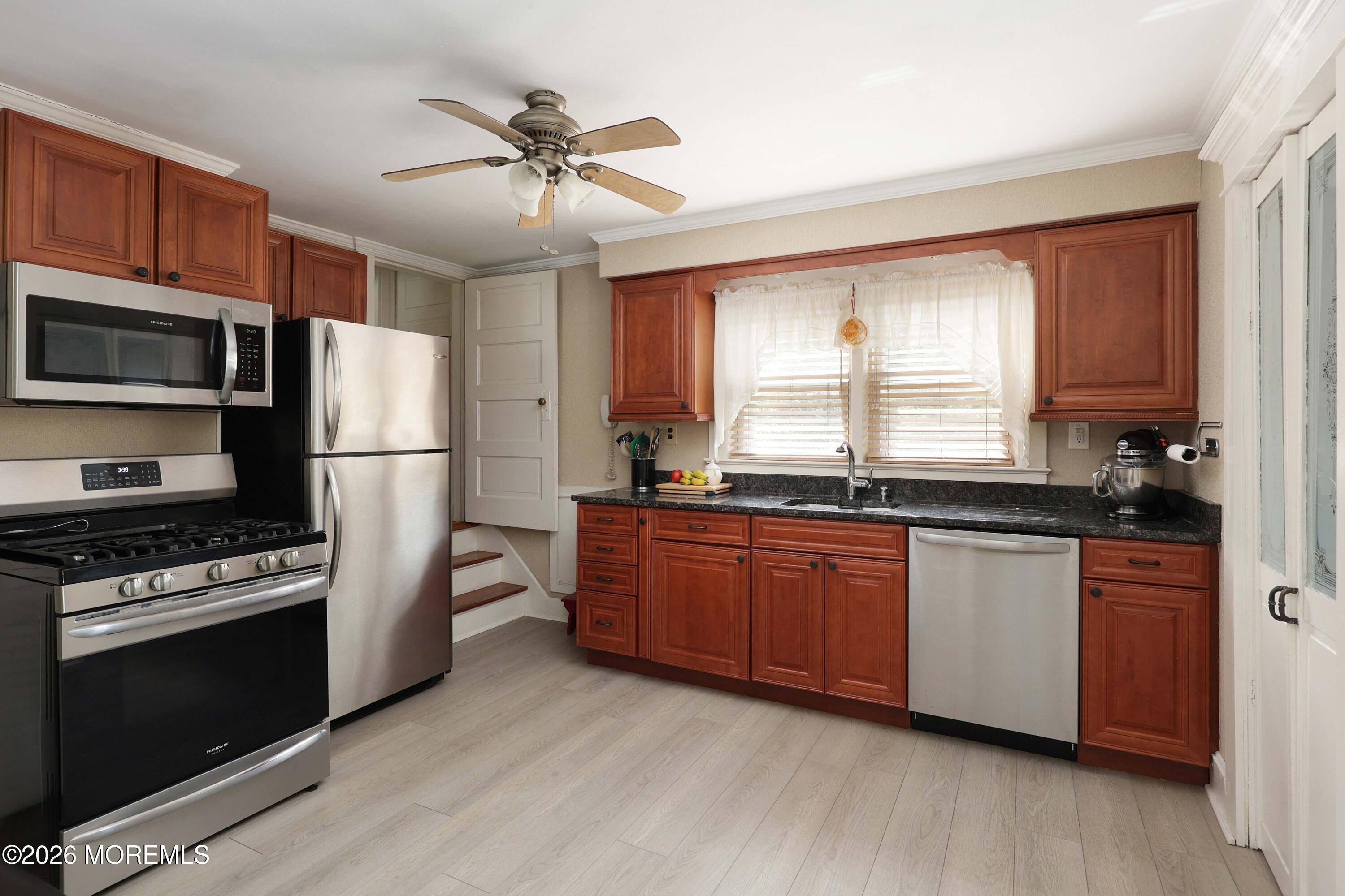 715 Howe Street Point Pleasant, NJ 08742 - Photo 12 of 45 a kitchen with granite countertop wooden floors stainless steel appliances a sink and a window