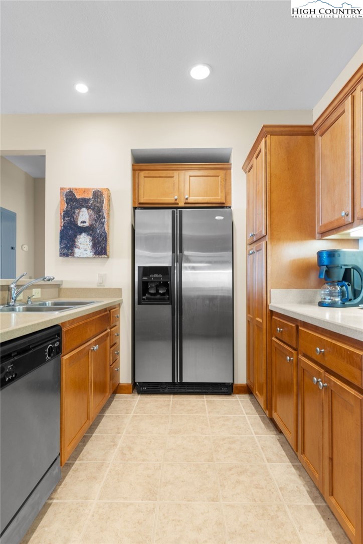 143 Wildflower Ridge, Unit 17D Sugar Mountain, NC 28604 - Photo 13 of 36 a kitchen with stainless steel appliances granite countertop a refrigerator and a stove top oven