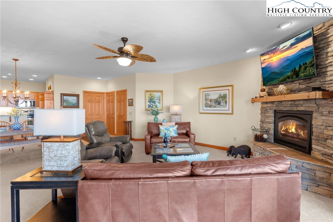 143 Wildflower Ridge, Unit 17D Sugar Mountain, NC 28604 - Photo 5 of 36 a living room with fireplace furniture and a flat screen tv