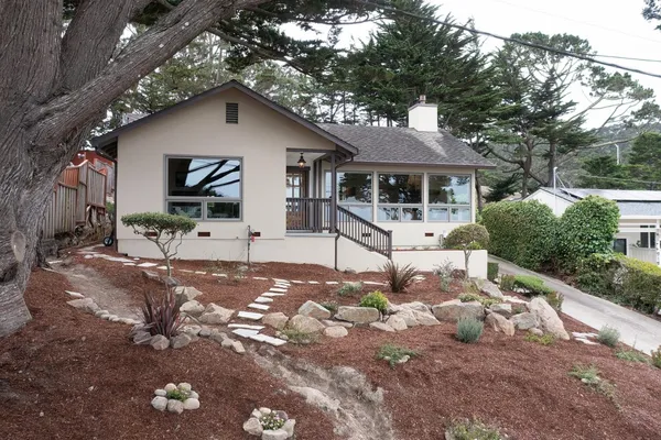a front view of a house with garden