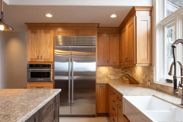 a kitchen with granite countertop a sink and stainless steel appliances