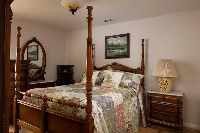 a bedroom with a bed and a dresser