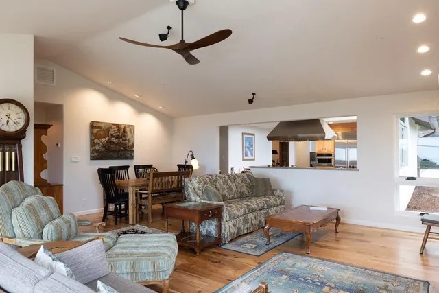 a living room with fireplace furniture and a wooden floor