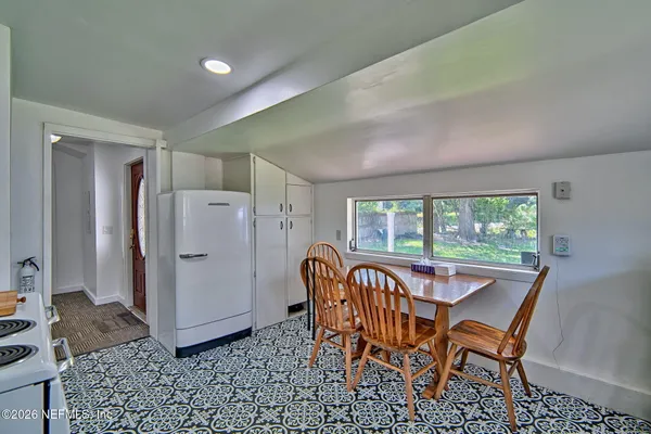 a dining room with furniture and window