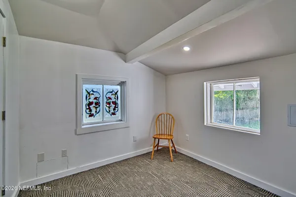 a view of a livingroom with workspace and a window