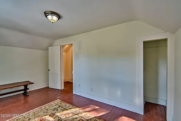 a view of room with window and wooden floor
