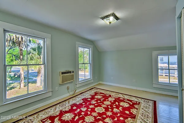 a room with window and rug