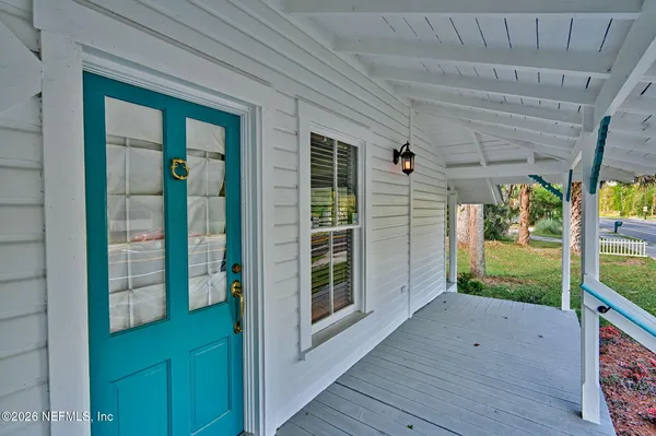 a view of a porch with wooden floor and roof