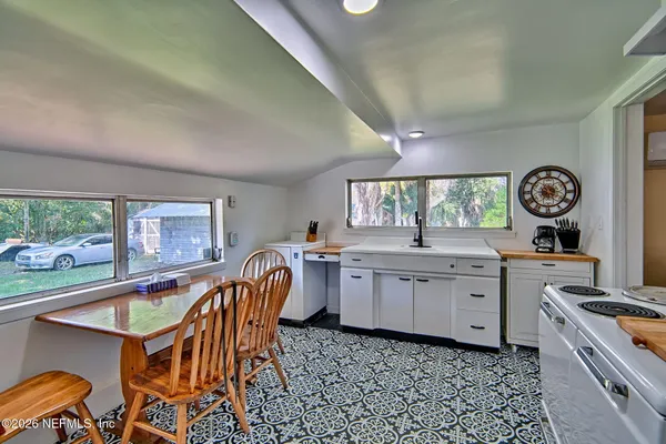 a kitchen that has a table and chair in it