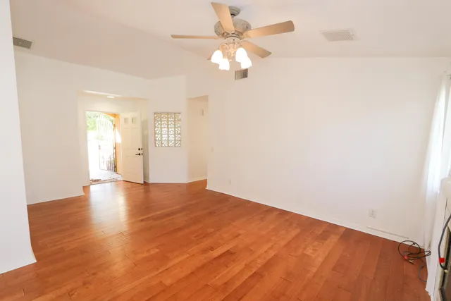 a kitchen with granite countertop a refrigerator stove top oven and sink