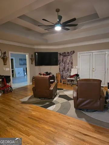 a living room with furniture and a flat screen tv