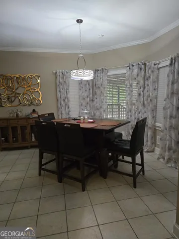 a dining room with a table and chairs