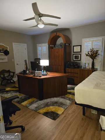 a room with a table chairs and wooden floor