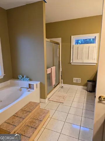 a bathroom with a bathtub and a sink