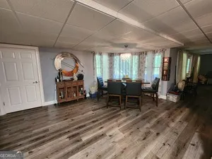 a living room with furniture a table and wooden floor