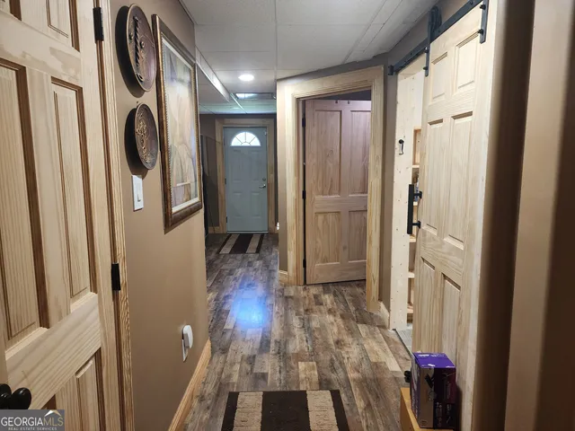 a view of a hallway with wooden floor and entryway