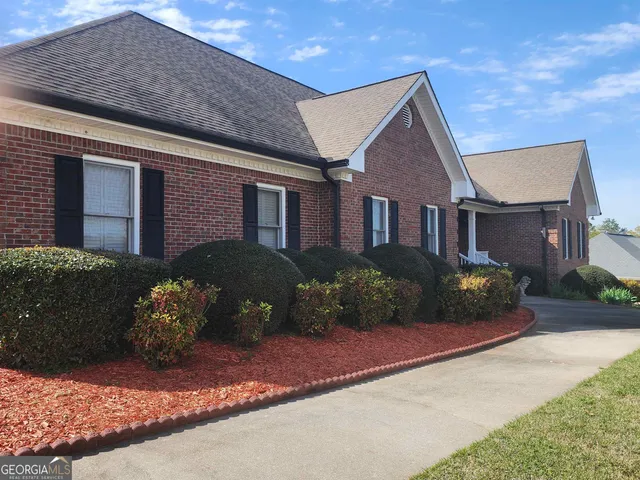 a front view of a house with a yard and outdoor seating