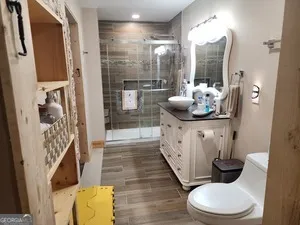 a bathroom with a sink toilet and shower
