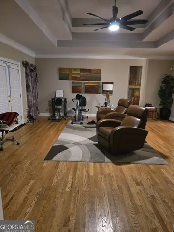 a living room with furniture a flat screen tv and a dresser