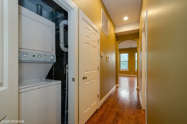 a view of bathroom with a hallway and wooden floor