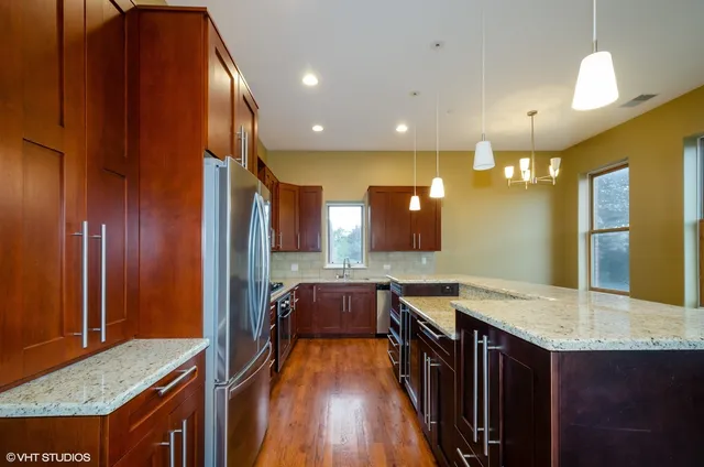 a bathroom with a granite countertop sink and a large mirror