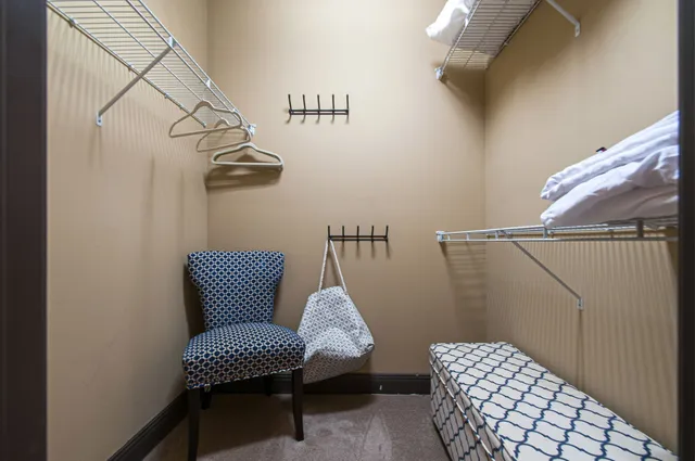 a wooden bench sitting next to a chair