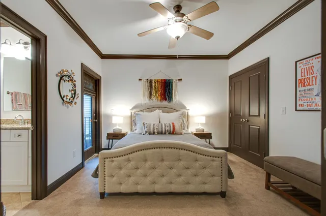 a spacious bedroom with a bed and a chandelier