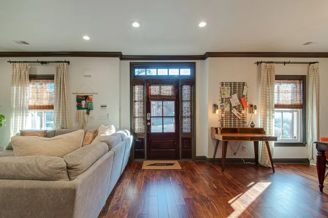 a living room with furniture and wooden floor