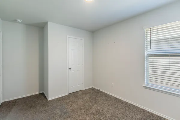 a view of an empty room and a window