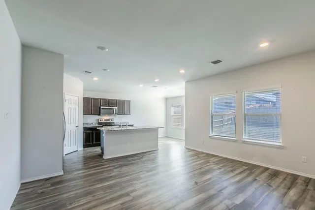 a kitchen with stainless steel appliances granite countertop a stove and a refrigerator