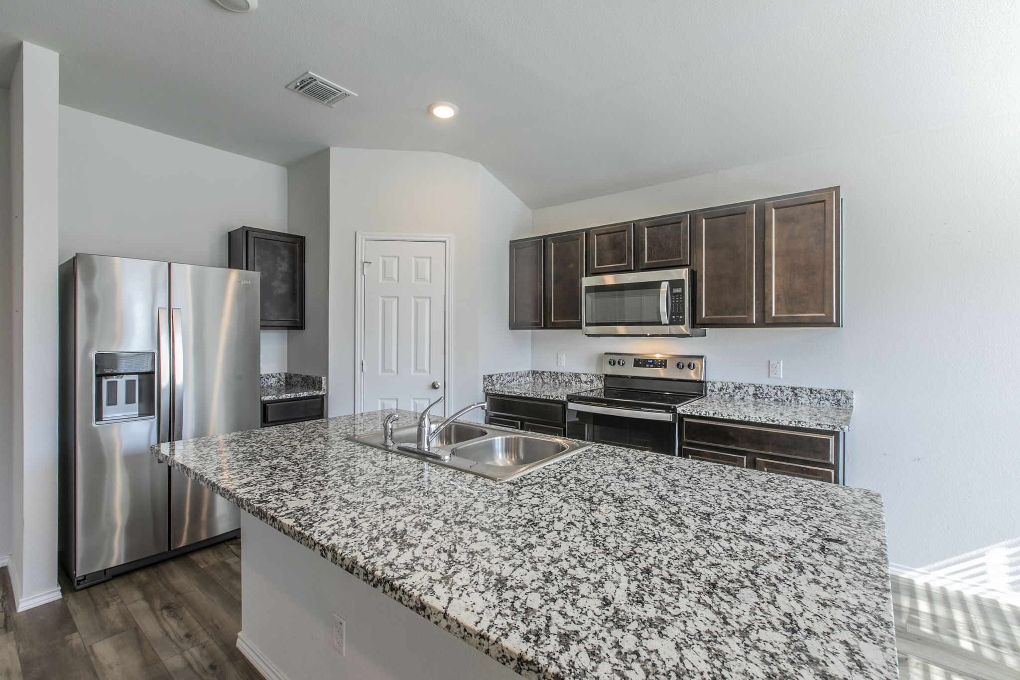 237 Poplin Lane Troy, TX 76579 - Photo 7 of 23 a kitchen with stainless steel appliances granite countertop a refrigerator and a stove top oven