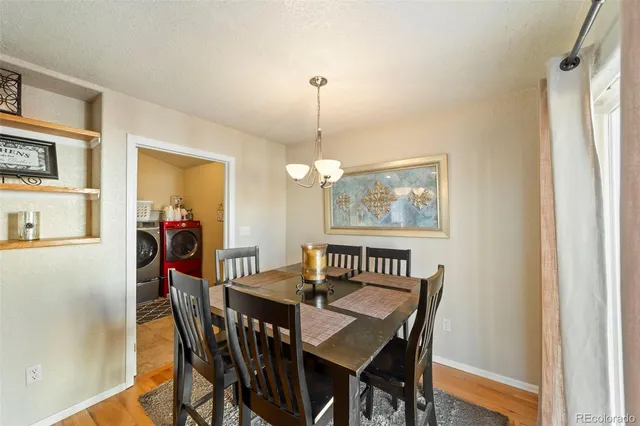 a view of a dining room with furniture window and wooden floor