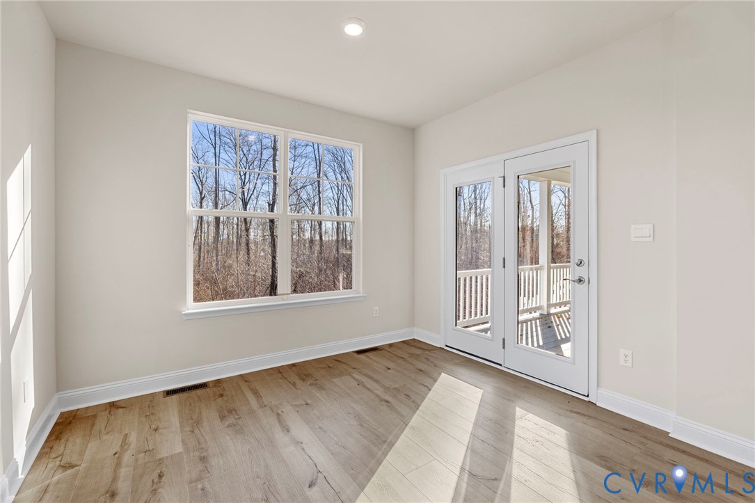2710 Maidens Road Powhatan, VA 23139 - Photo 13 of 33 an empty room with wooden floor and windows