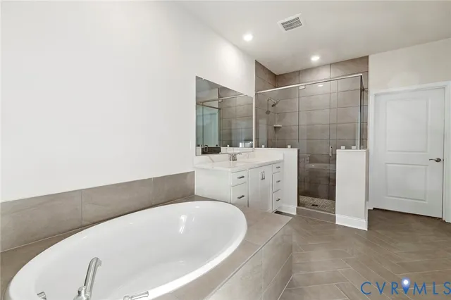 a bathroom with a bathtub and a sink
