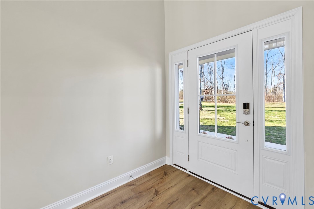 2710 Maidens Road Powhatan, VA 23139 - Photo 2 of 33 a view of an empty room with wooden floor and a window