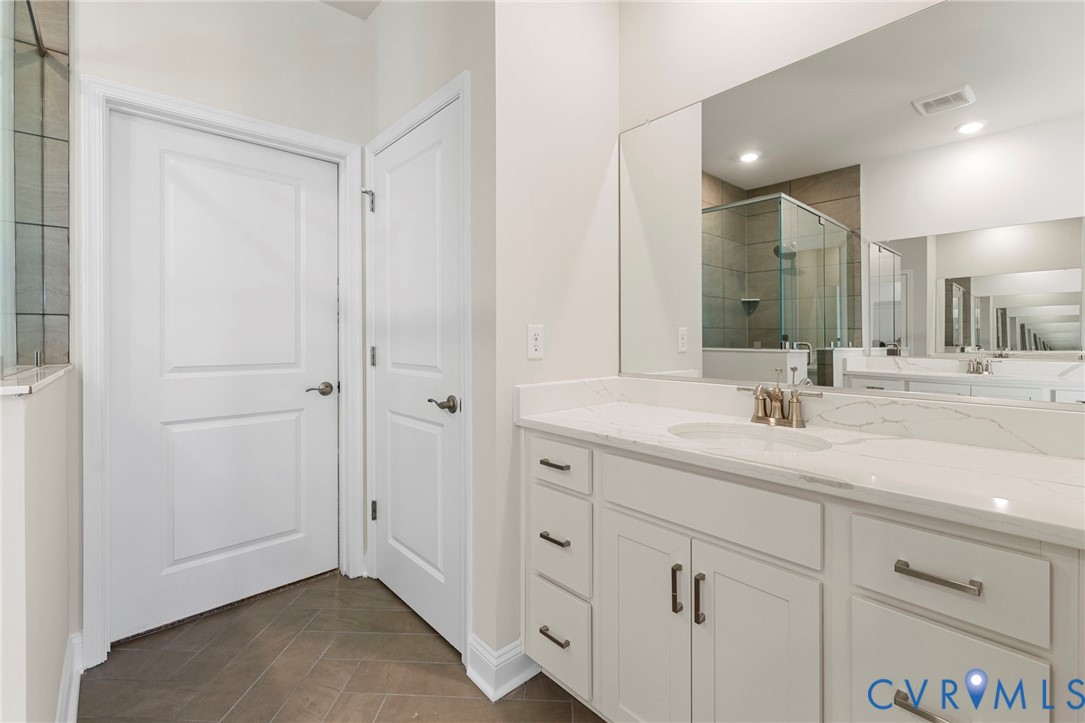2710 Maidens Road Powhatan, VA 23139 - Photo 21 of 33 a bathroom with a double vanity sink and mirror