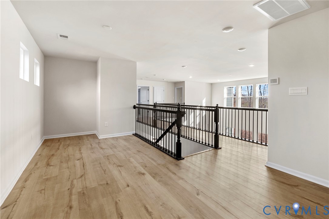 2710 Maidens Road Powhatan, VA 23139 - Photo 24 of 33 a view of a hallway with wooden floor and windows