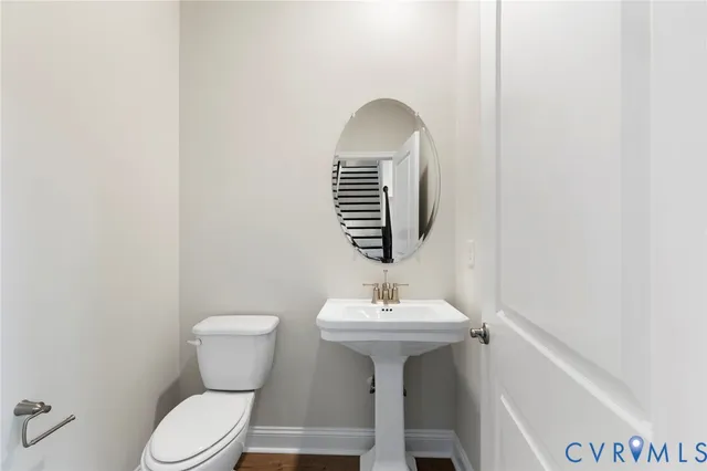 a bathroom with a sink toilet and mirror
