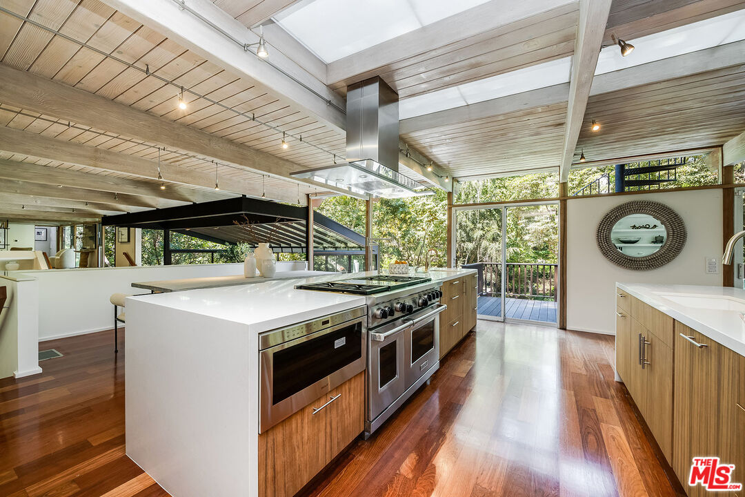 681 Brooktree Road Santa Monica, CA 90402 - Photo 16 of 32 a kitchen with a stove and a wooden floors