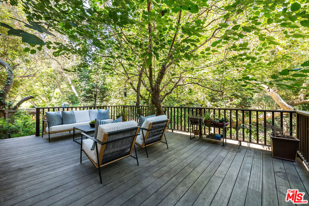 681 Brooktree Road Santa Monica, CA 90402 - Photo 30 of 32 a view of a roof deck with wooden floor and outdoor seating